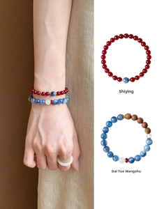 Close-up of vintage agarwood agate and blue crystal beaded bracelets with gold spacers