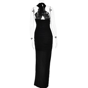 Detailed back view of a black halter maxi dress featuring pleated texture and tie-up details