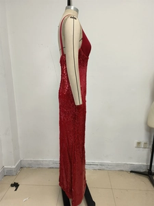 Detail of red sequined mermaid evening gown showing texture and slim-fit waist design