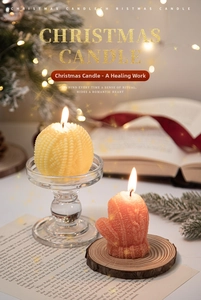 Cozy Christmas scene with glove-shaped and embossed spherical scented candles on wood base