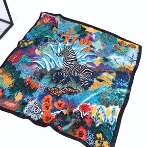 Detail of satin scarf featuring vibrant jungle zebra print and smooth silk texture