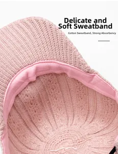 Detailed macro view of the inner sweatband and soft knit texture of this pink winter cap