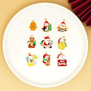Flat lay of Christmas DIY alloy charms including Santa and reindeer on white tray