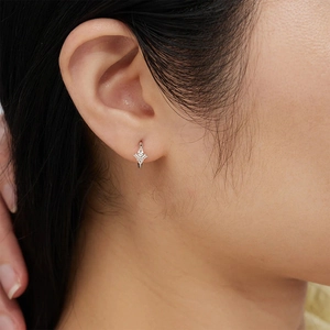 Close-up of S925 sterling silver hoop earring with three sparkling cubic zirconia stones