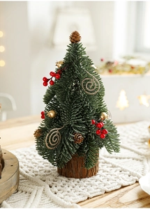 Miniature green Christmas tree with snowy needles and red berries on a rustic wooden base