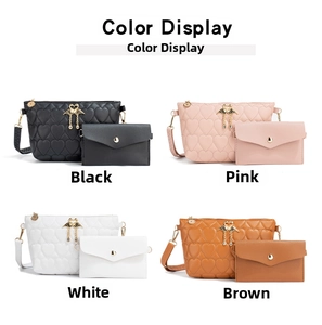 Detailed color display of quilted heart bags with swan pendants in black, pink, white and brown