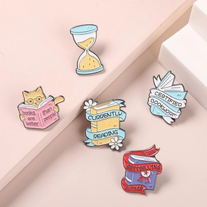 Five-piece magic book cat enamel pin set with hourglass and currently reading theme