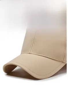 Close-up of beige baseball cap brim showing durable stitching and structured shape