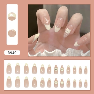 Cute creamy yellow French press-on nails with cartoon bear and heart lace patterns