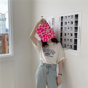 Detailed view of pink leopard print canvas pouch with secure metal zipper closure