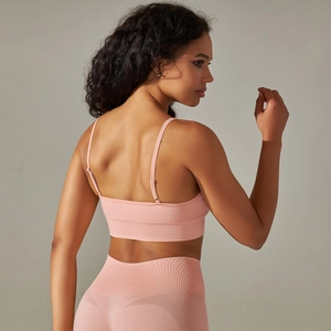 Detail of pink seamless ribbed sports bra with mesh vents and thin adjustable straps