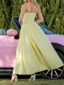 Elegant light yellow spaghetti strap maxi dress with ruffled hem for summer vacations