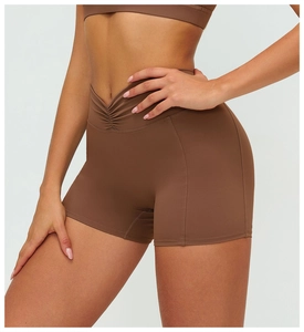 Close-up of V-shaped high waist and stitching detail on deep brown brushed yoga shorts