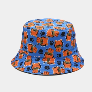 Detailed view of the double-sided bucket hat featuring blue fabric with orange lion prints