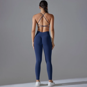 Detail of cross-back sports bra and high-waist leggings in deep blue knit fabric