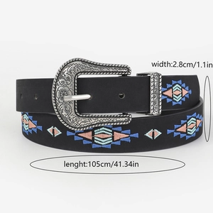 Detail of embroidered leather belt with floral patterns and silver engraved buckle