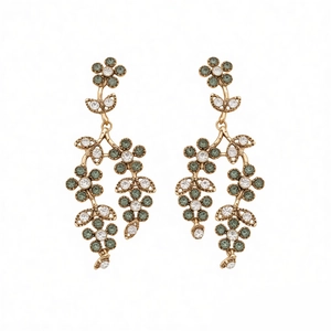 Vintage gold flower drop earrings with forest green and white crystals on white background