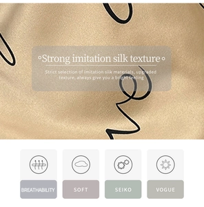 Close-up of champagne gold imitation silk fabric featuring soft black script print details