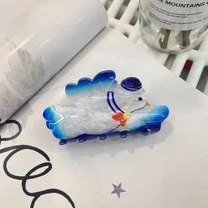 Detail of cartoon seagull hair claw clip in blue and white sailor style gradient acrylic
