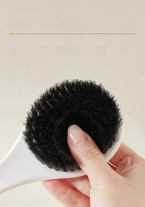 Close-up of flexible black bamboo charcoal bristles on a long-handle bath body brush
