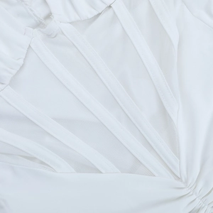 Close-up of white mesh splicing and textured stripe details on elegant evening dress