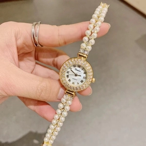Luxury women's quartz watch with pearl bracelet strap and sparkling diamond bezel
