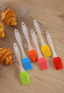 Detailed view of colorful 6-piece silicone pastry brushes with croissants on wood
