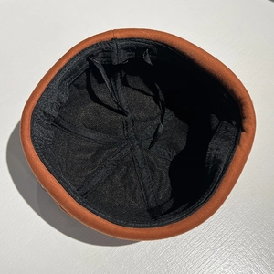 Orange and black docker cap showing durable inner lining and adjustable drawstrings