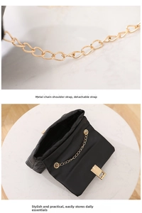 Close-up of black quilted shoulder bag featuring gold chain strap and detachable buckle