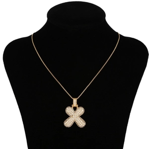 Hip hop style gold letter X pendant necklace with sparkling cubic zirconia on neck model