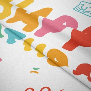 Detail shot of white tapestry showing soft plush texture and colorful Happy text