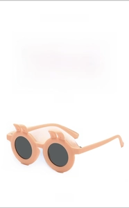 Detail view of rabbit ear kids sunglasses with light orange frame and round dark lenses
