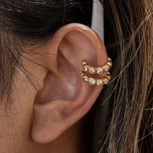Close-up of 18K gold-plated double-row ear cuffs featuring sparkling round white zircons