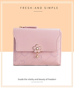 Detailed close-up of pink PU leather wallet featuring floral stitching and metal flower clasp