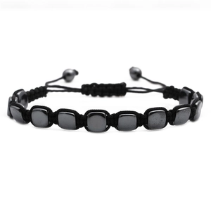 Macro detail of adjustable hand-woven black hematite beaded bracelet with square beads