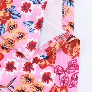 Detail shot of the hemline stitching and vibrant floral print on knit fabric