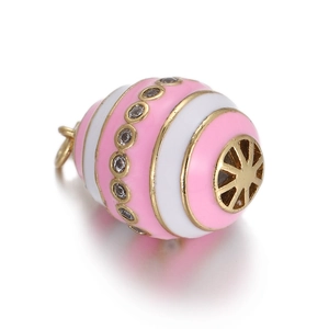 Macro shot of pink enamel evil eye charm with gold plating and cubic zirconia inlay