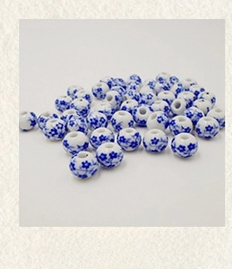 Close-up of 10mm blue and white porcelain ceramic beads with traditional floral patterns