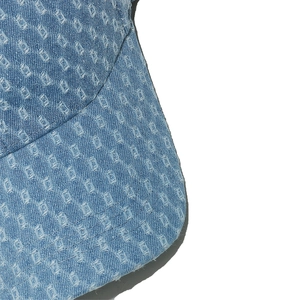 Detailed macro shot of distressed light blue denim fabric with trendy square cut-outs