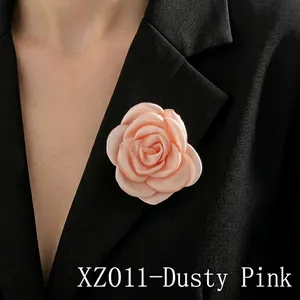 Detail of dusty pink fabric rose brooch XZ01 on a black blazer lapel with layered petals