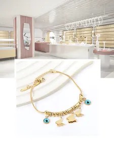 Detail of gold butterfly evil eye snake chain bracelet with blue beads and adjustable clasp