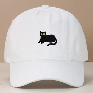 Close-up of a white vintage washed baseball cap featuring a black cat embroidery detail