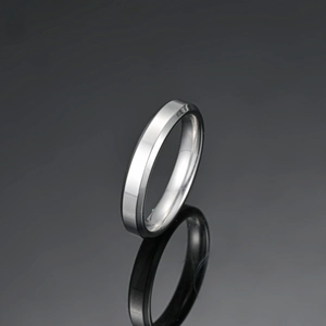 Polished silver stainless steel ring with double beveled edges and glossy finish reflection