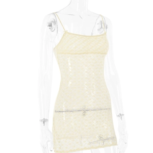 Detailed close-up of light yellow lace short dress with sheer floral patterns and adjustable straps