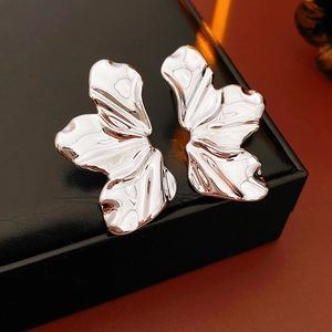 Detailed close-up of silver textured leaf earrings featuring a unique crumpled petal design
