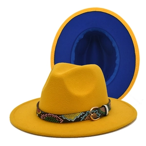 Detail of yellow and blue bicolor fedora hat featuring a snake print band and gold buckle