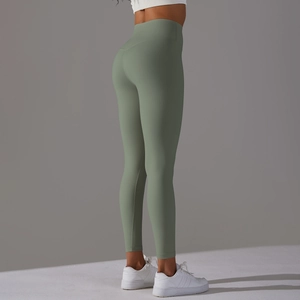 Detail view of high-waist yoga pants in sage green with seamless push-up effect