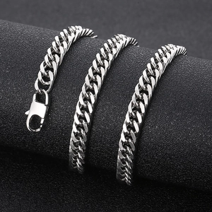 Macro detail of silver stainless steel curb chain necklace with lobster clasp on display