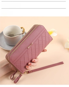 Pink quilted leather clutch wallet with dual zipper compartments and a wrist strap