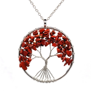 Detailed view of handmade silver wire tree of life pendant with natural red stones
